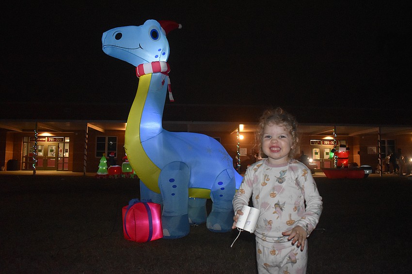 Bradenton's Collins Krueger, 3, is all smiles for her homemade binoculars and the glowing dinosaur.