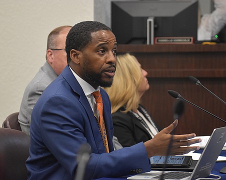 Jamara Clark, director of student enrollment for the School District of Manatee County, presents information on school choice to members of the school board on Dec. 9.