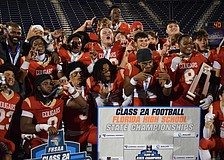 Cardinal Mooney football players gather for photos after winning the 2025 FHSAA Class 2A state championship over Jacksonville Bolles. On Dec. 10, the Cougars became champions of Florida for the second time in three years.