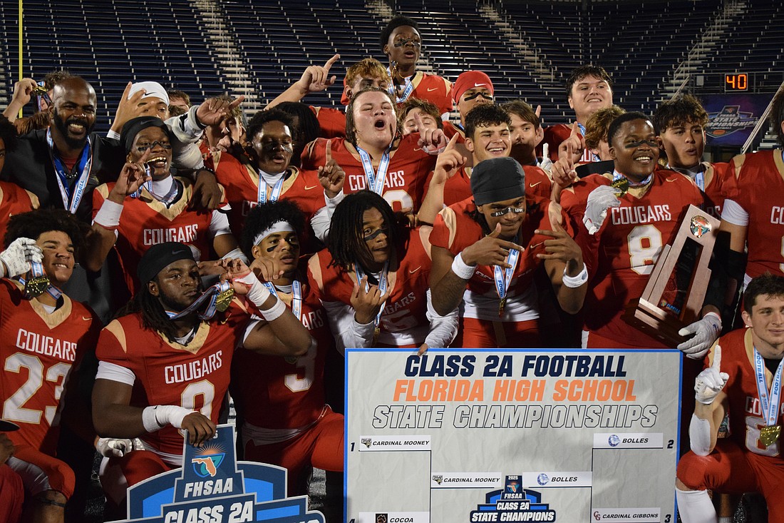 Cardinal Mooney football players gather for photos after winning the 2025 FHSAA Class 2A state championship over Jacksonville Bolles. On Dec. 10, the Cougars became champions of Florida for the second time in three years.