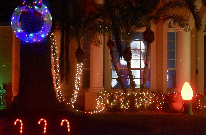 Santa greets visitors from the window of 9605 Governor's Club Place in The River Club.