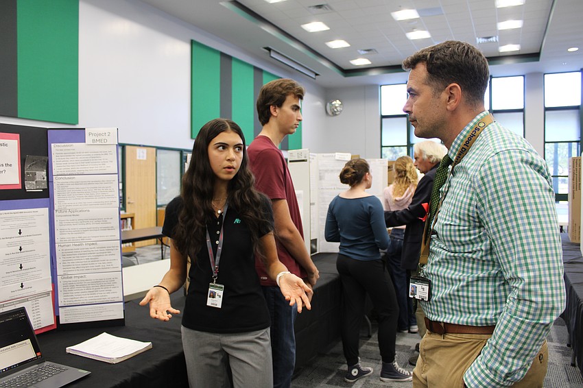 Sophomore Selma Onus presents her project to Thomas Bellantonio, an assistant principal at the school.