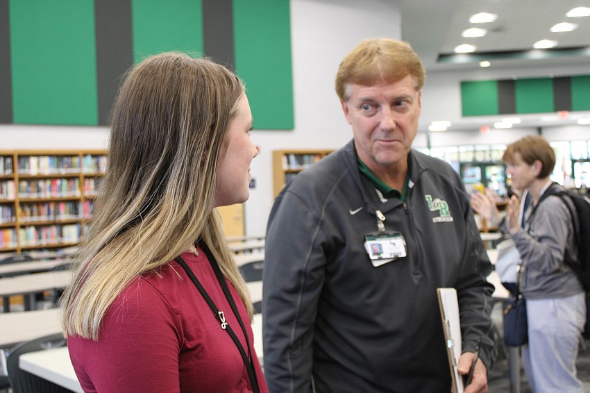 Sophia Mitchell, a sophomore, gets advice from science teacher and judge Bryan Thomas. Mitchell did a project on using artificial intelligence in healthcare.