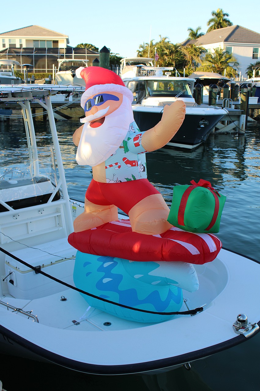Santa surfs onto the scene at the Bird Key Blessing and Lighting of the Fleet.