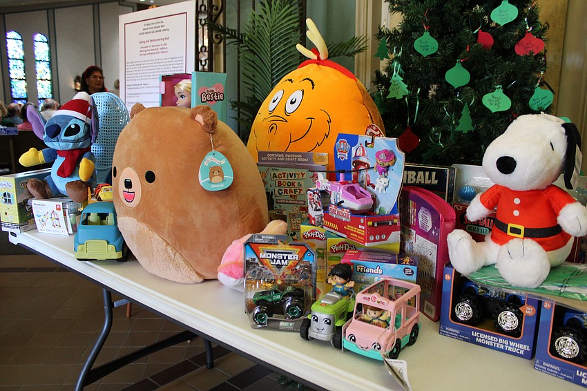 Concert attendees filled three tables with their toy contributions to be given to children of the diocese.