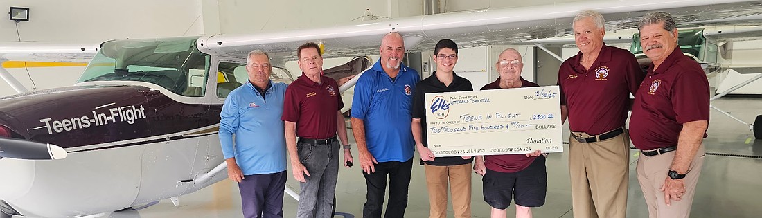 Palm Coast Elks veterans committee members Steve Gallagher and David
Valinski, Exalted Ruler Pete Lehnertz, Teens-In-Flight student Elijah, Teens-In-Flight founder and Elk Col. Jack Howell, veterans committee chairman Jerry DiMenna and committee member Sean Reardon. Courtesy photo