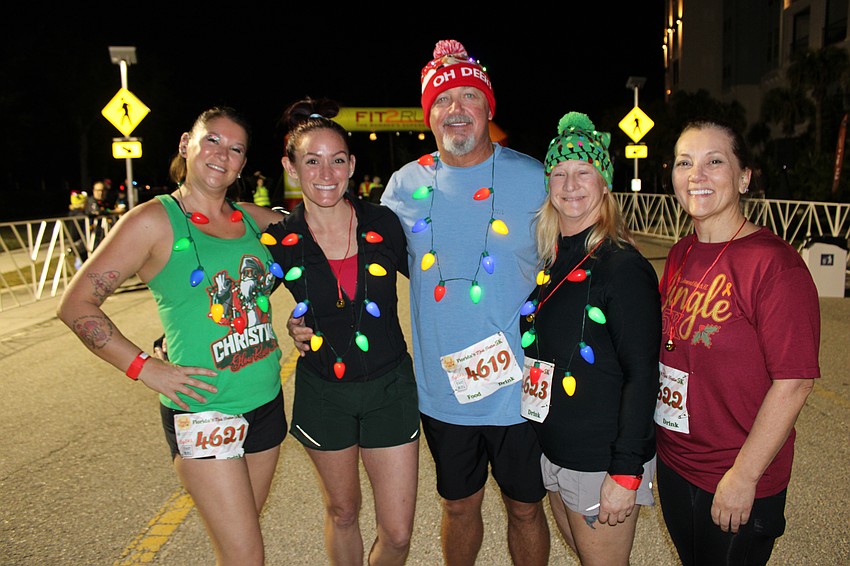 Jenn Lammi, Jenn Shaw, Mike Shaw, Caroline Magnusson and Debbie Stickel prepare to run the Jingle 5K. The women all became friends through Lammi, who is a trainer at Pumps Fitness.