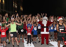 Santa (Steven Trudell of St. Petersburg) gets the runners fired up just before the start of the 2025 Jingle 5K Dec. 12 in Lakewood Ranch.