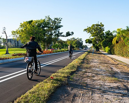 Cyclists utilize the bike lanes on Gulf of Mexico Drive along the newly completed Country Club Shores turn lane project portion of the street. The 0.84-mile segment marks the first example of the town’s Complete Streets vision.