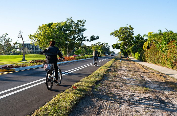Cyclists utilize the bike lanes on Gulf of Mexico Drive along the newly completed Country Club Shores turn lane project portion of the street. The 0.84-mile segment marks the first example of the town’s Complete Streets vision.