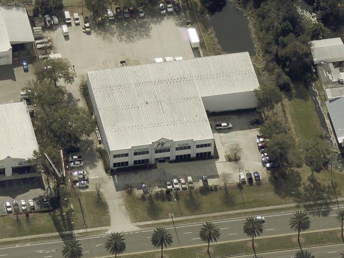 The Woodsman Kitchen & Floors showroom building at 11732 Beach Blvd.