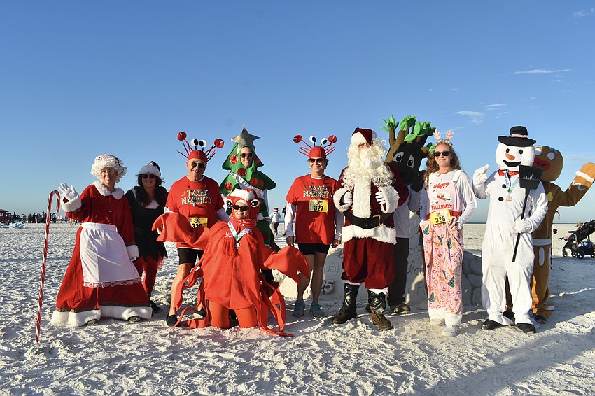 Greg Corban (third from left), Katy Corban (center) and Katelyn Corban (third from right) pose with a variety of creatures from Sarasota County Parks, Recreation and Natural Resources.