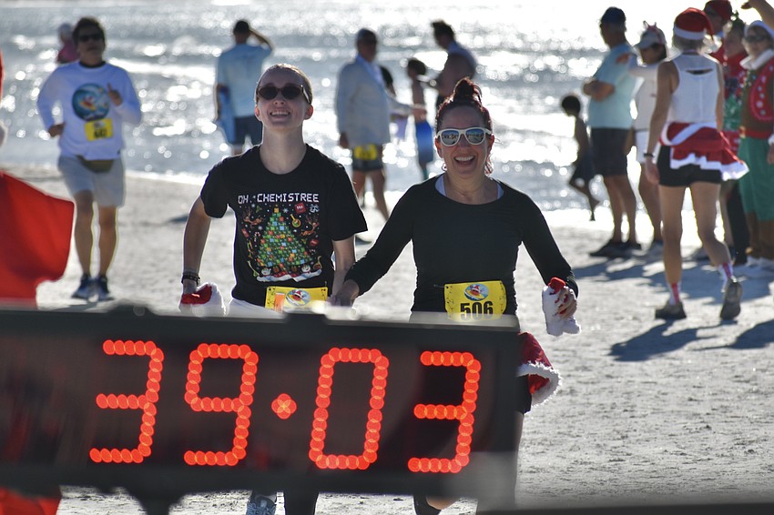Tasman Henry and Julie Henry come in for the finish line.