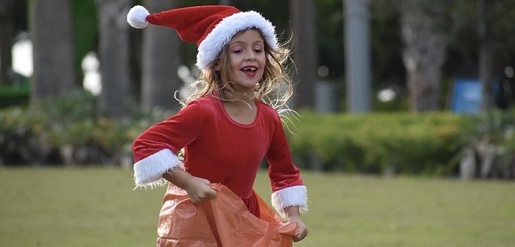 Lylah MacDonald, 6, hops along in the sack race.