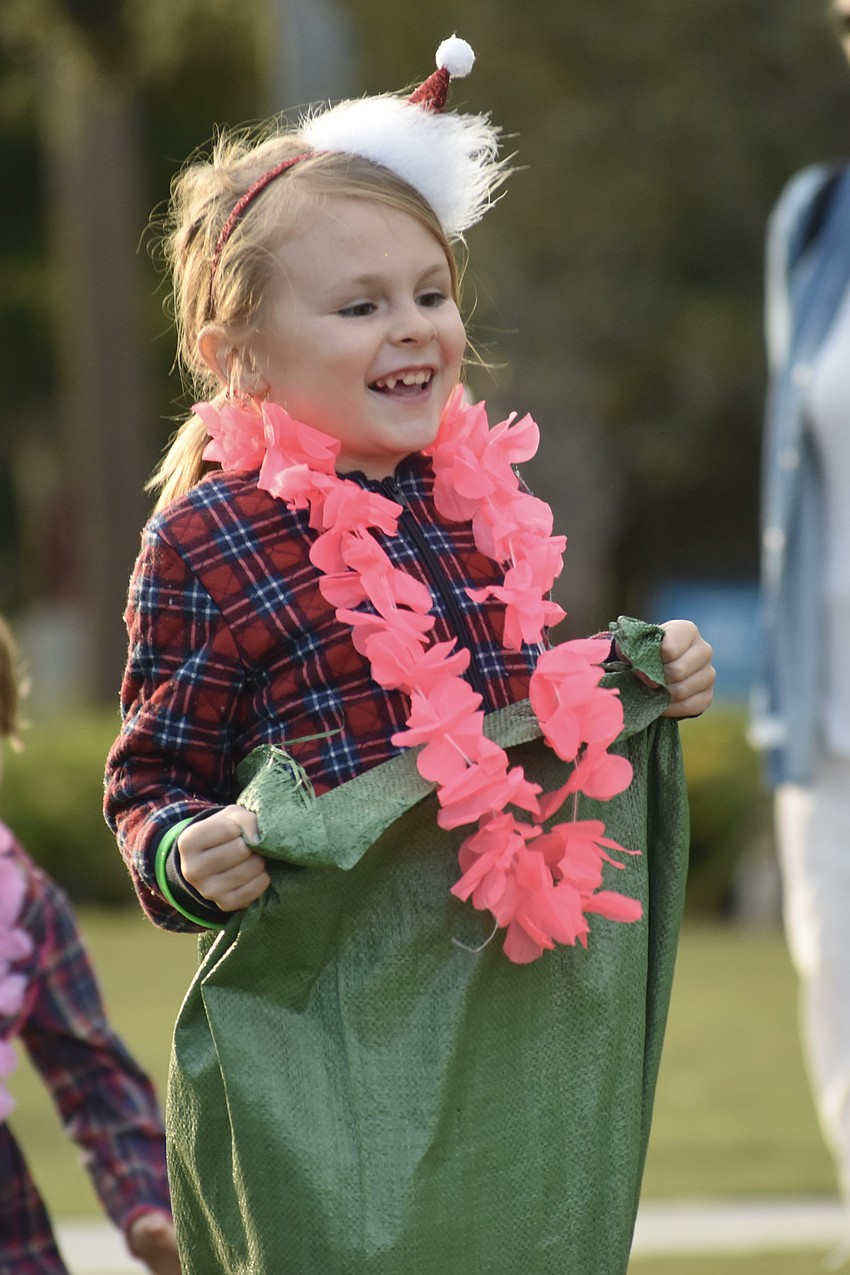 Charlie Tavernier, 7, hops along in the sack race.
