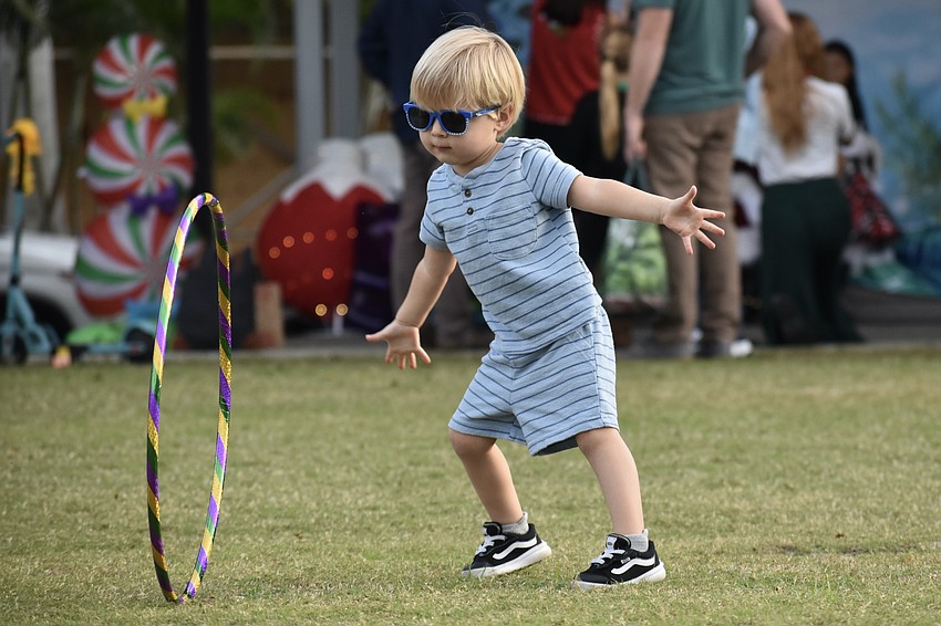 Jude Tomchinsky, 2, practices hula hoop tricks like rolling it backwards.