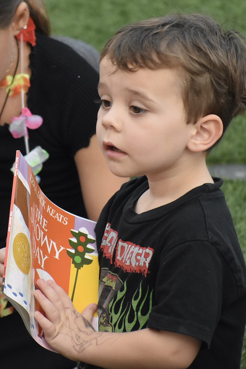 Rowen Shank, 3, listens to Mr. Stevey.