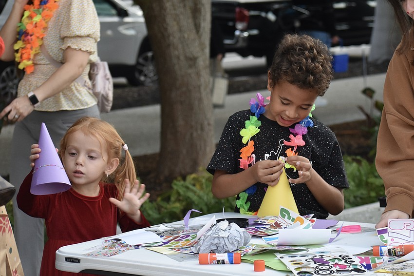 Yana Kostyuk, 3, and Dominic Parker, 7, work on a craft project with the John and Mable Ringling Museum of Art.