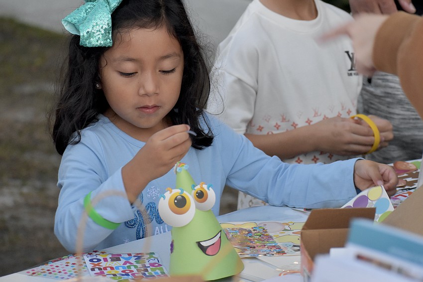 Claire Garcia, 5, works on the craft project with the John and Mable Ringling Museum of Art.