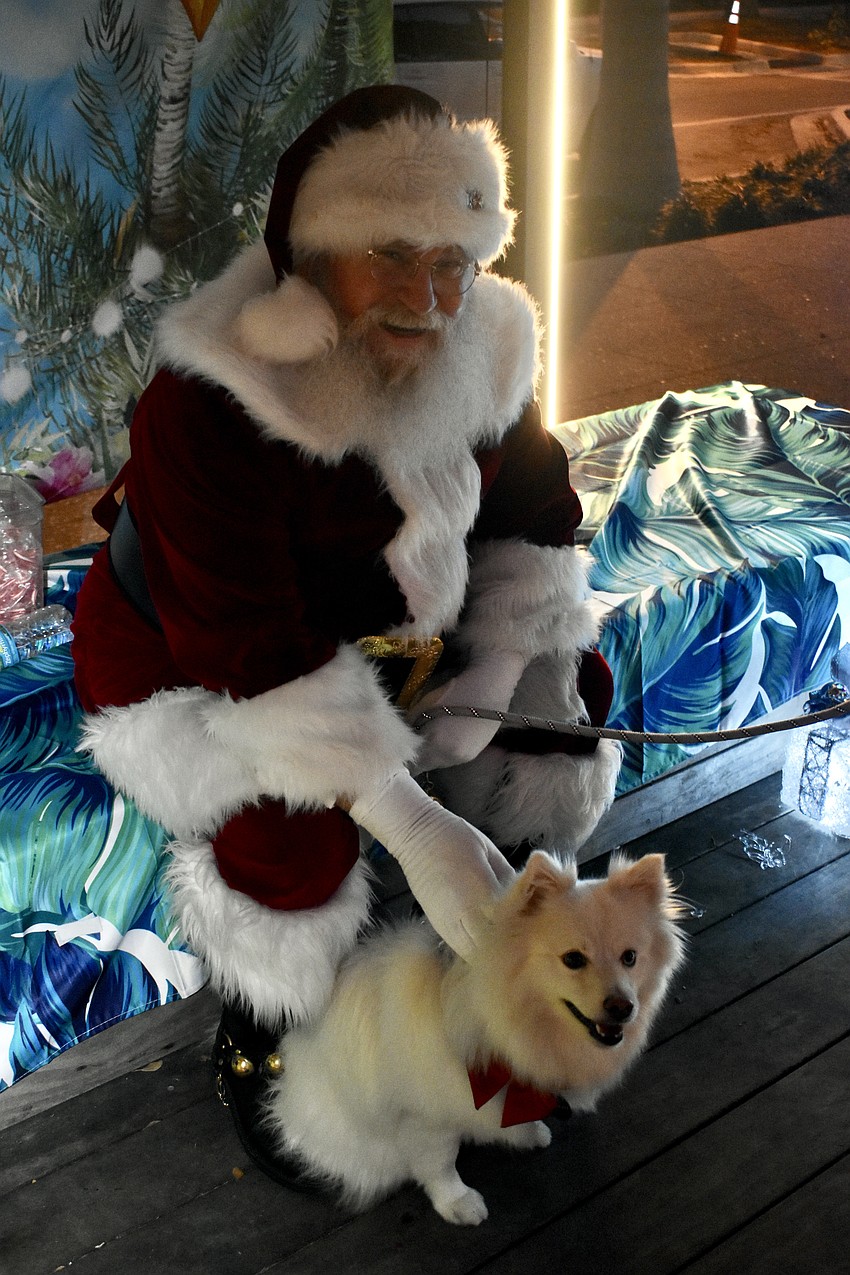 Santa Claus pets Charlie