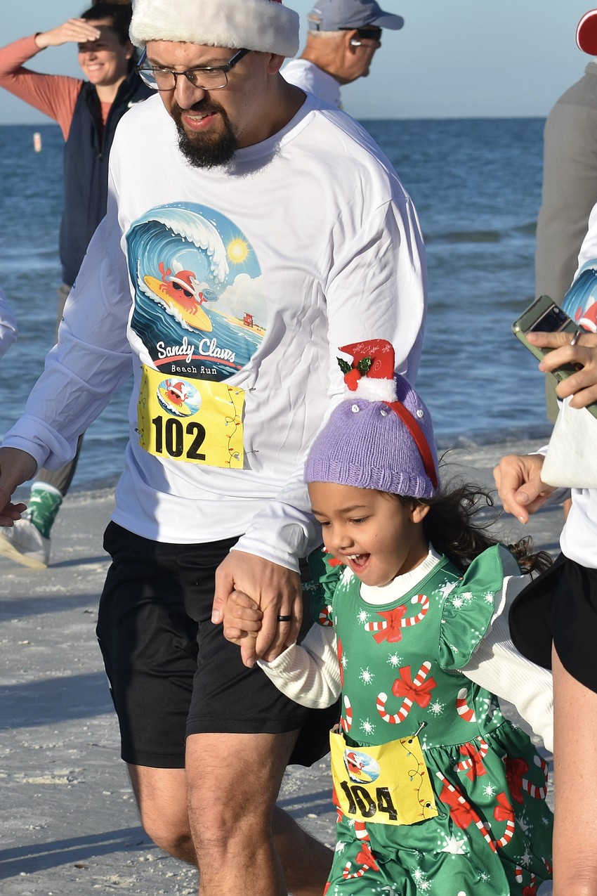 Nick LeBoutillier runs with his daughter Jasmine LeBoutilier, 4.