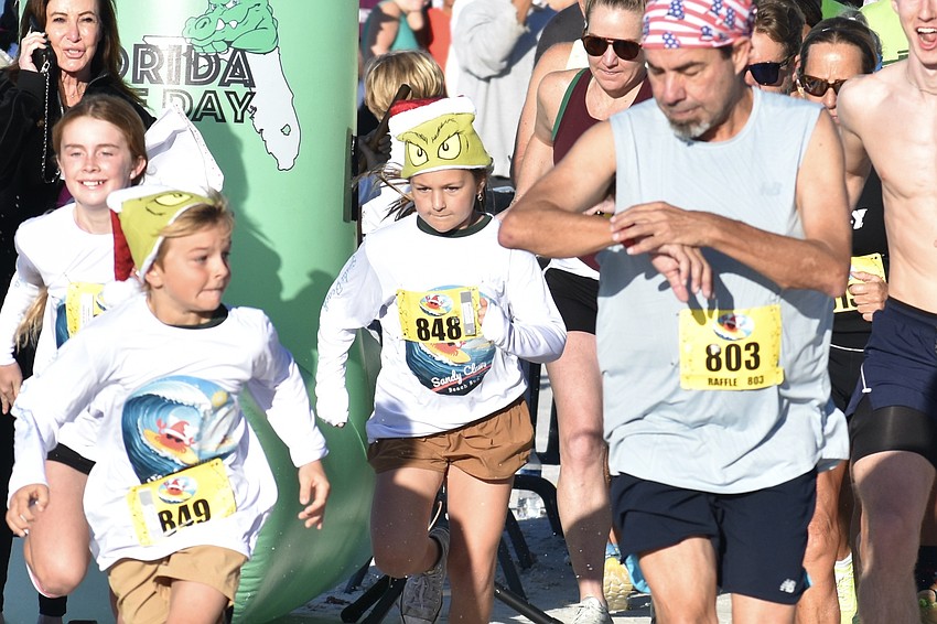 Jackson McCoy, 8, Stella McCoy, 9, and Paul Opitz head out on the race.