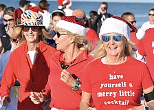 Joni Hill, Cate Douglas and Gaby Hayashi make their way across the beach.
