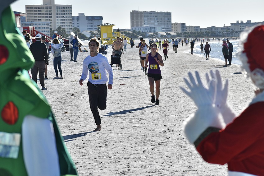 Lance Stukaloff and Emily MacQuarrie are applauded as they approach the finish line.