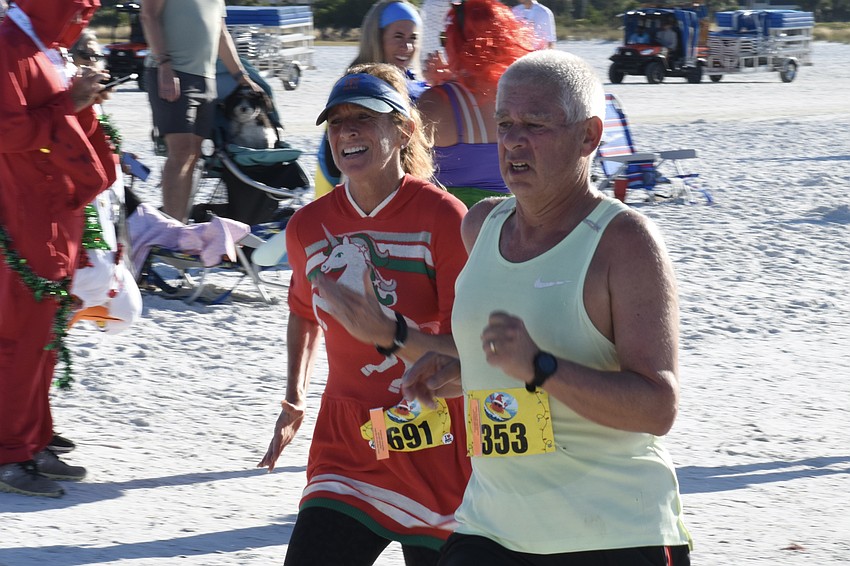 April Shereda and Donald Favre head for the finish line.