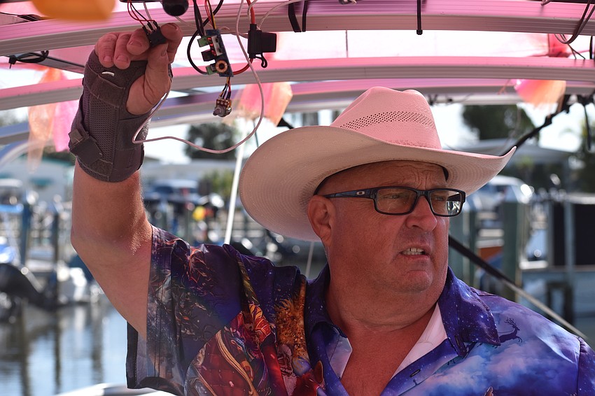 Mark Hoffman operates the wings on the flamingo from his boat.