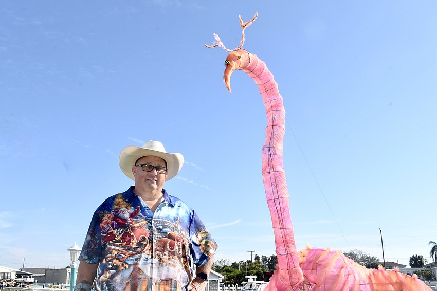 Mark Hoffman stands beside his flamingo creation.