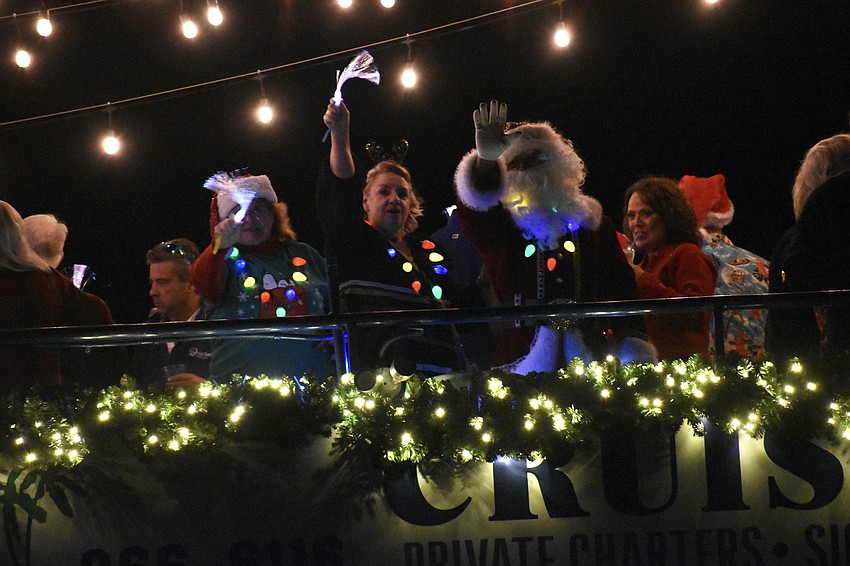 Guests wave from LeBarge Tropical Cruises.
