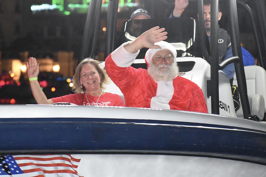Terri Antonelli waves with Santa Claus.