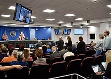 Residents line up behind the podium to object to a proposal for Altman Rye Townhomes.