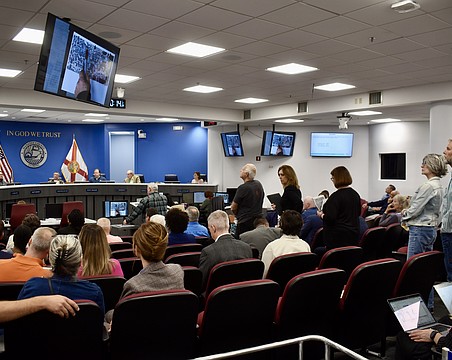 Residents line up behind the podium to object to a proposal for Altman Rye Townhomes.