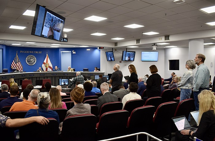 Residents line up behind the podium to object to a proposal for Altman Rye Townhomes.