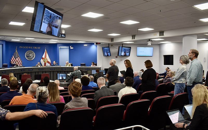 Residents line up behind the podium to object to a proposal for Altman Rye Townhomes.