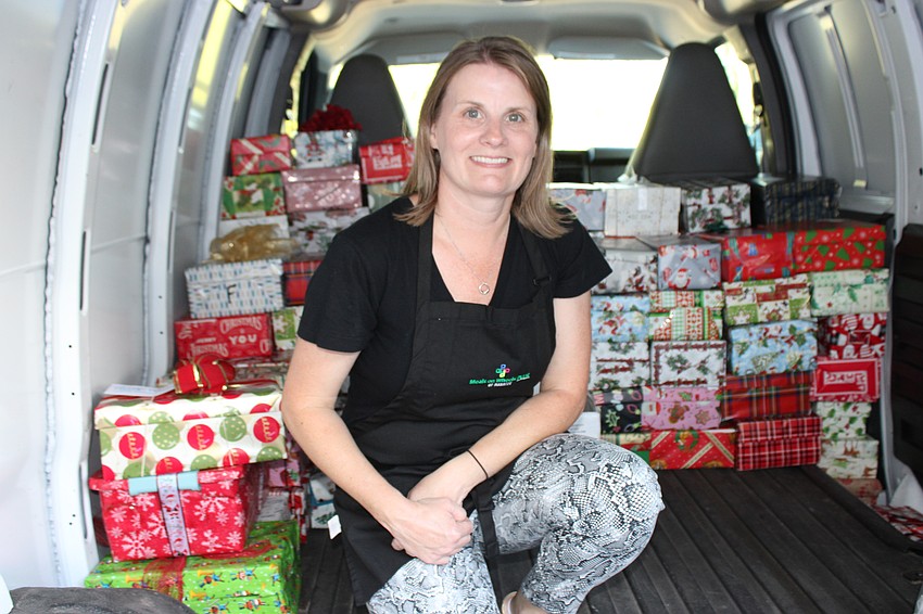 Amy Towery, the vice president of development for Meals on Wheels Plus of Manatee, begins packing a van during the shoebox drive.