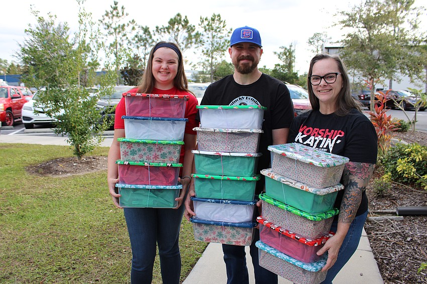 Bradenton's Lilly Brown, Michael Brown, and Monica Kalosis, all representing the Bradentucky Bombers roller derby organization, delivered 50 packed shoeboxes.