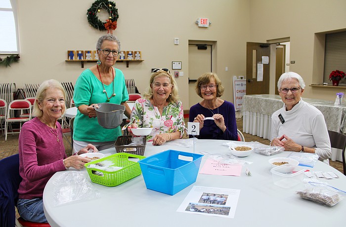 Cindy Ritchell, Ann Quackenbush, Brenda Korthauer, Beverly Sutton and Kit Torchia all lend a helping hand in packing seeds to send internationally to farmers who need them. Quackenbush is a driving force behind Hope Seeds, a charitable ministry through Christ Church of Longboat Key.