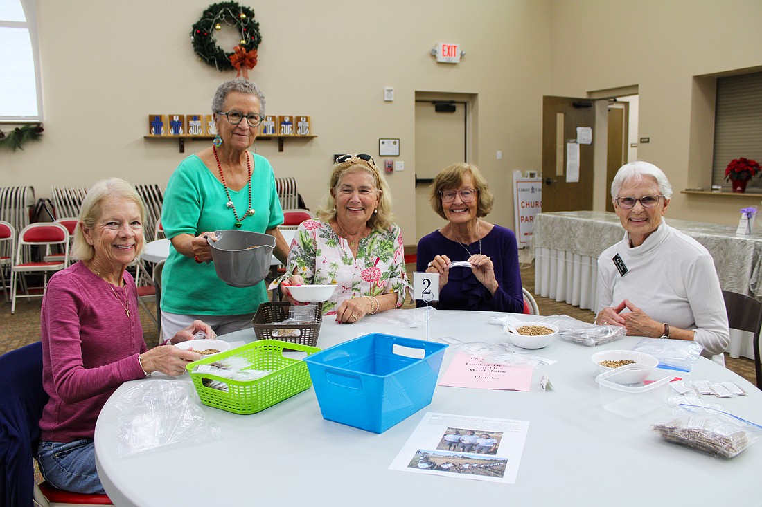 Cindy Ritchell, Ann Quackenbush, Brenda Korthauer, Beverly Sutton and Kit Torchia all lend a helping hand in packing seeds to send internationally to farmers who need them. Quackenbush is a driving force behind Hope Seeds, a charitable ministry through Christ Church of Longboat Key.