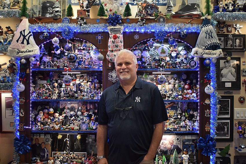 Ron Goldstein, former general counsel for the New York Yankees, poses for a photo with his expansive collection of Yankees ornaments. Since 1989, the holidays and the Bronx Bombers have gone hand-in-hand for him.