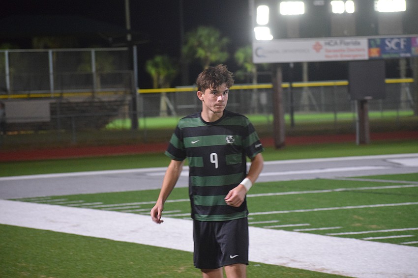 Louka Coué, a senior forward/midfielder for the Mustangs, eyes the field before a throw-in from his teammate. Louka Coué, a senior forward/midfielder for the Mustangs, eyes the field before a throw-in from his teammate.