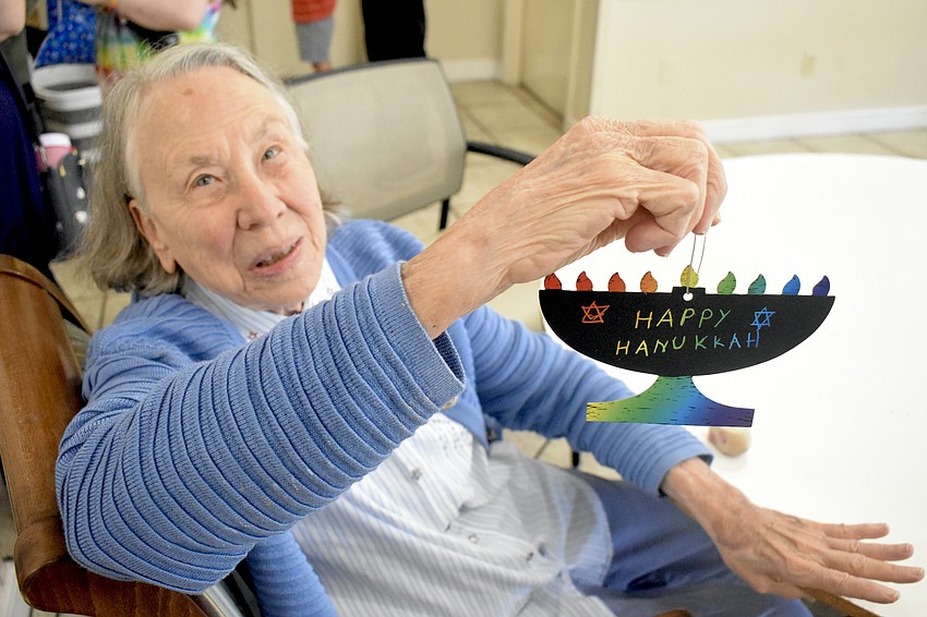 Margaret Taylor just added a Christmas tree in her room, but she enjoys taking part in the festivities of all holidays. She holds a decoration from the event. Margaret Taylor just added a Christmas tree in her room, but she enjoys taking part in the festivities of all holidays. She holds a decoration from the event.