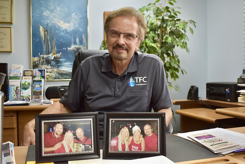 Pastor Phil Derstine keeps old photos of Christmas caroling on his desk.