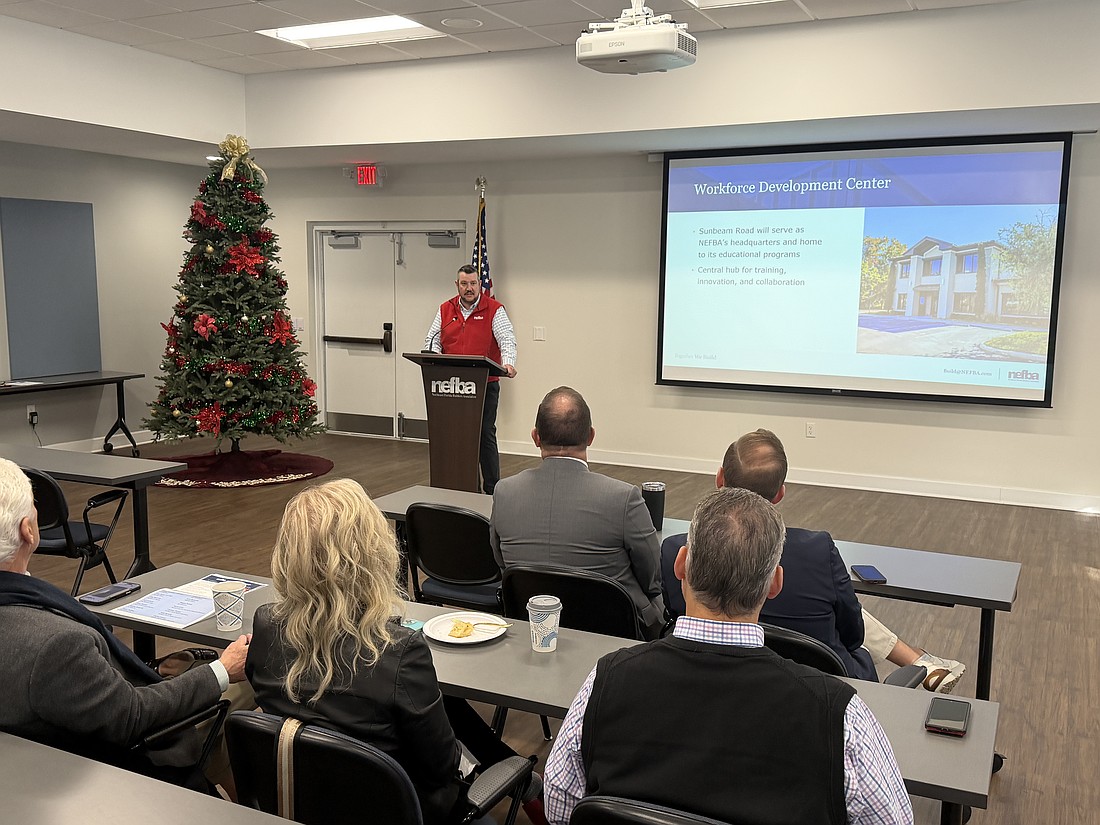 Northeast Florida Builders Association Executive Officer Jessie Spradley explains the group’s fundraising efforts on Dec. 16.
