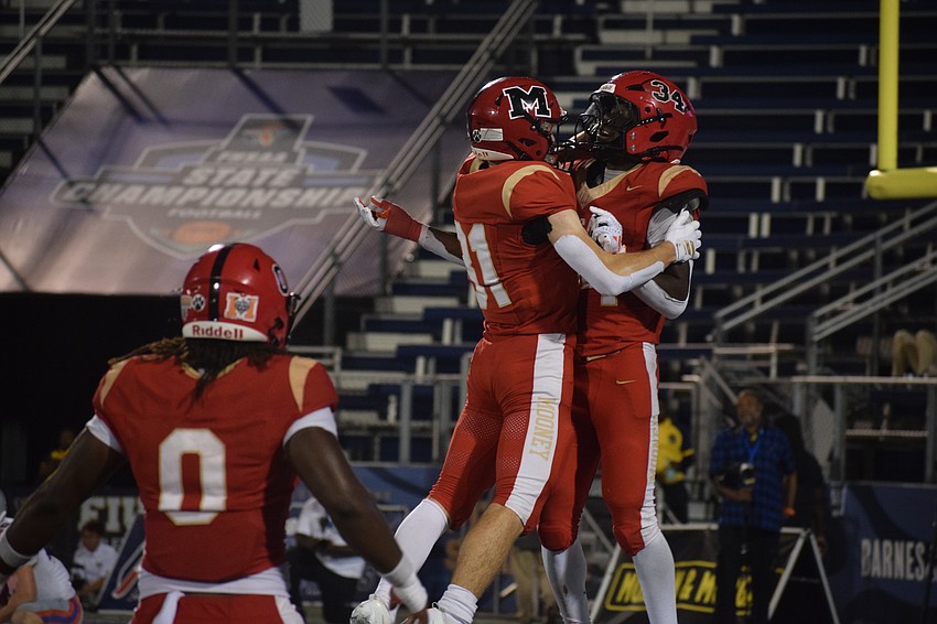 Zackery Samuel Jr. (left) looks to join in on the fun as Mason Jordan (center) and Connail Jackson (right) celebrate after a Jackson touchdown.