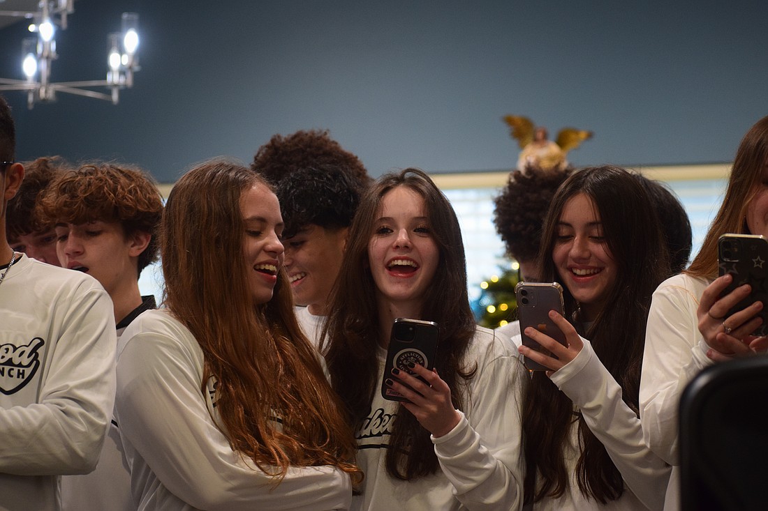 Livia Zamperlini-Ramos (left), Anna Chop (center) and Bailey Loring (right) share some joy while singing "Last Christmas."