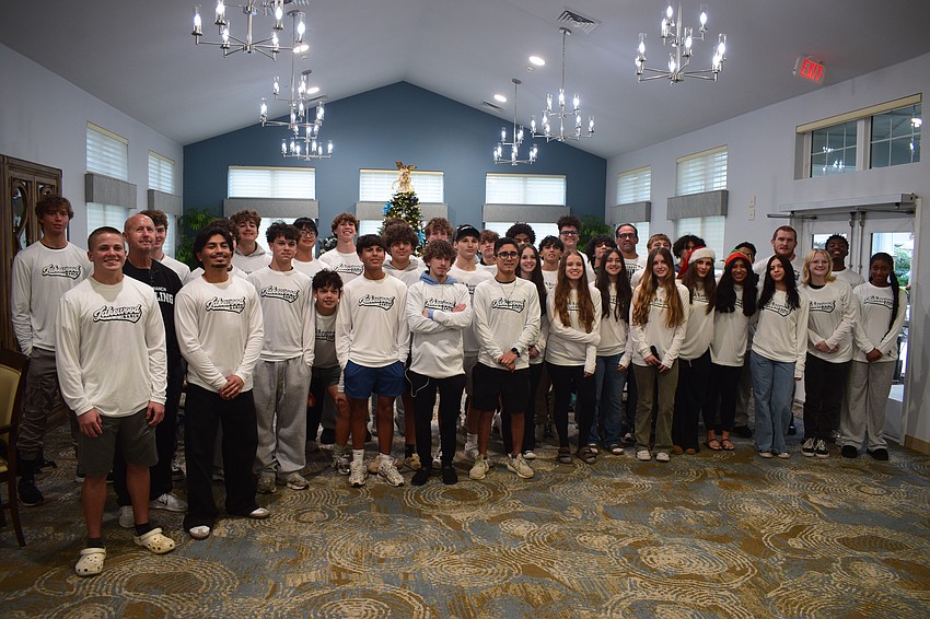 Lakewood Ranch wrestling gathers together for a photo on Dec. 15 in the dining area at Cypress Springs Gracious Retirement Living.