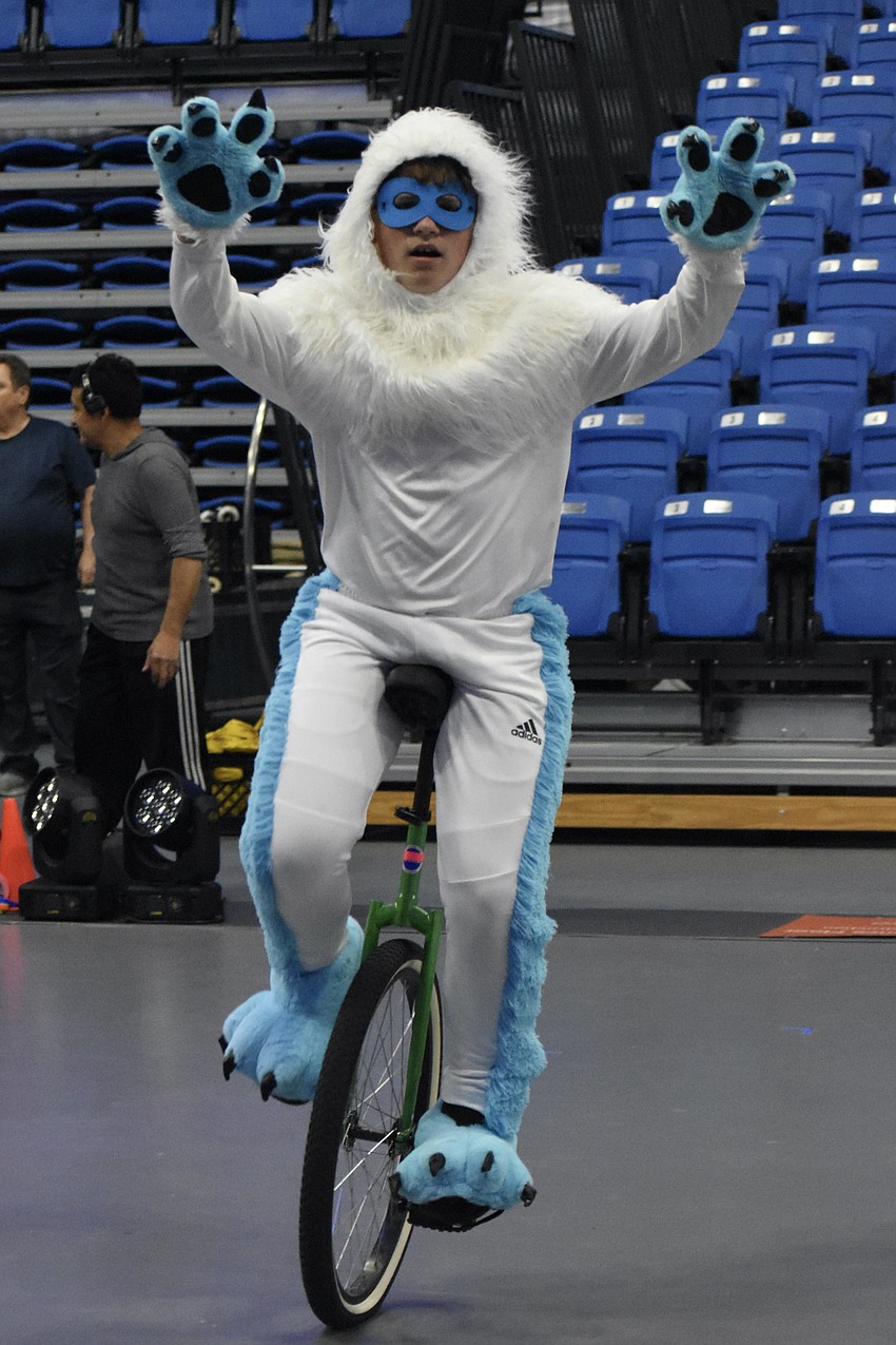 Timothy Deev, 13, rehearses the unicycle act as a Yeti.